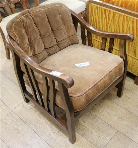A 1930s stained beech armchair